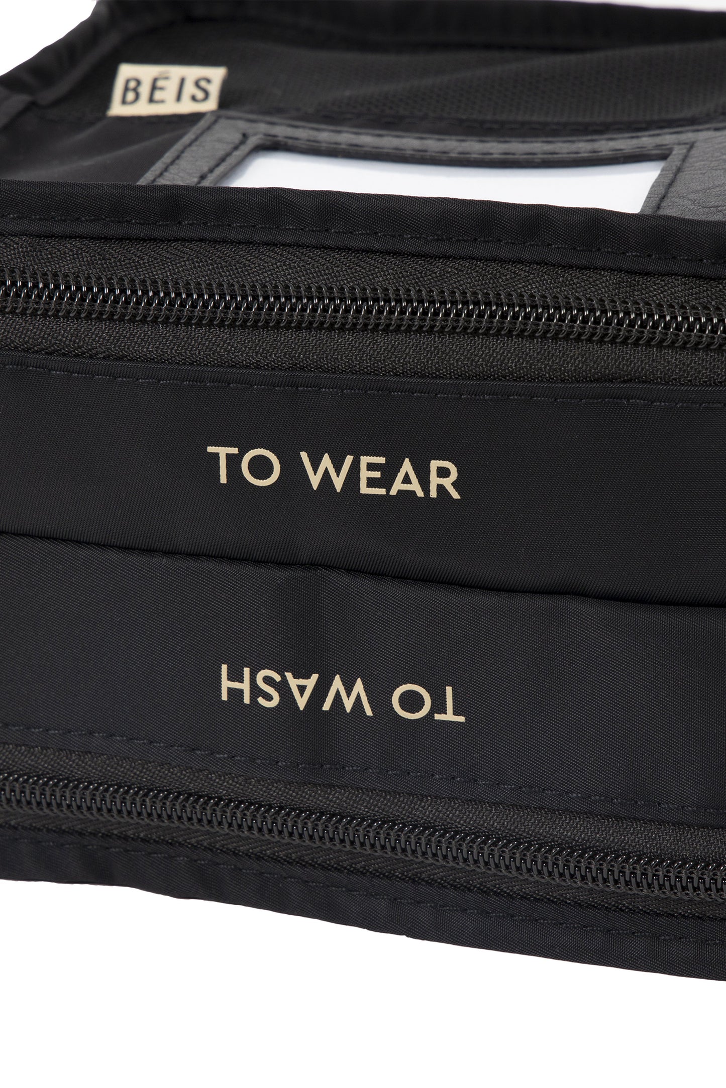 Close up, displaying the gold writing on bag, "to wash" and "to wear"