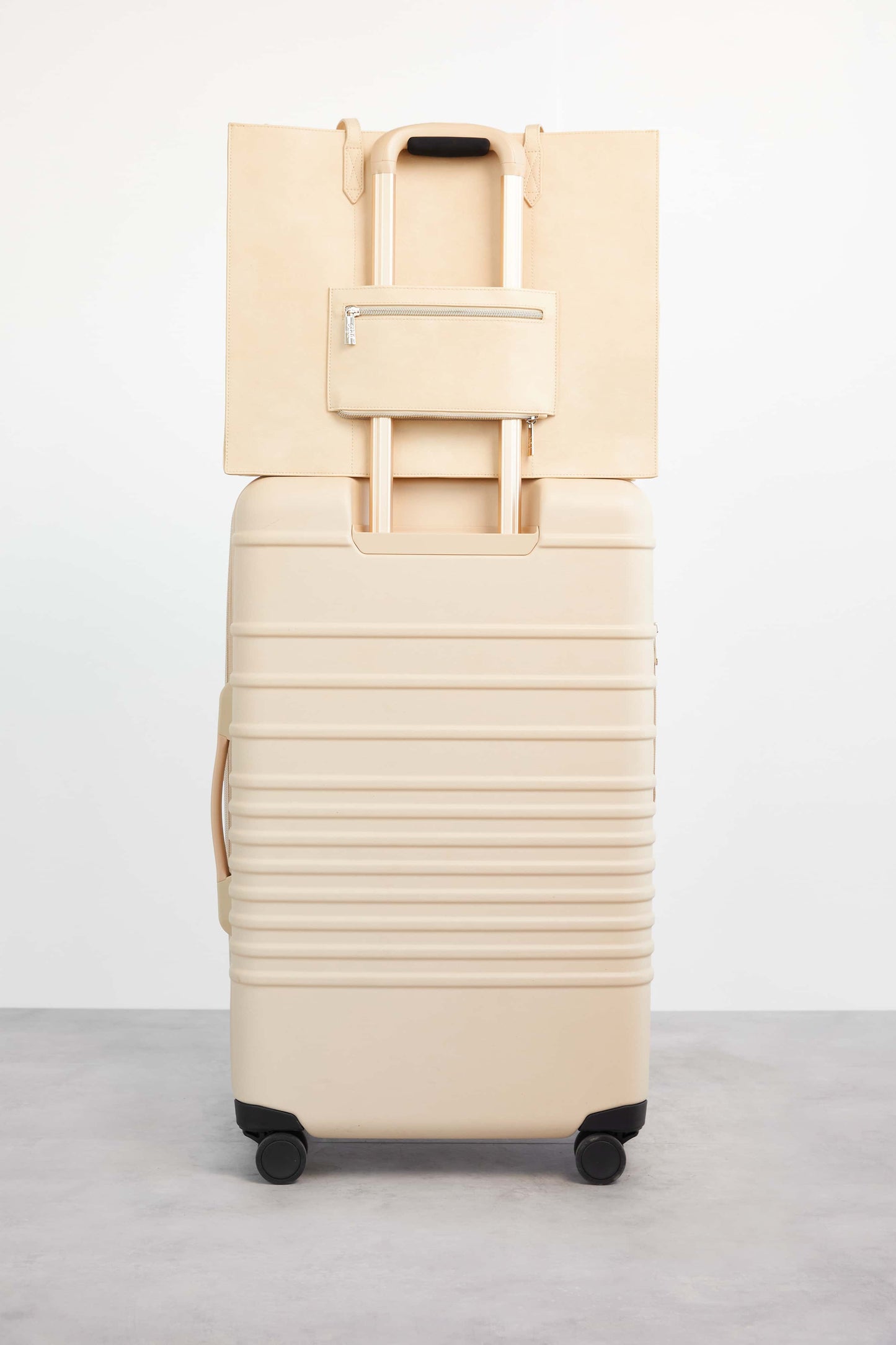 Work Tote Beige Back with Trolley Sleeve Stacked on Luggage