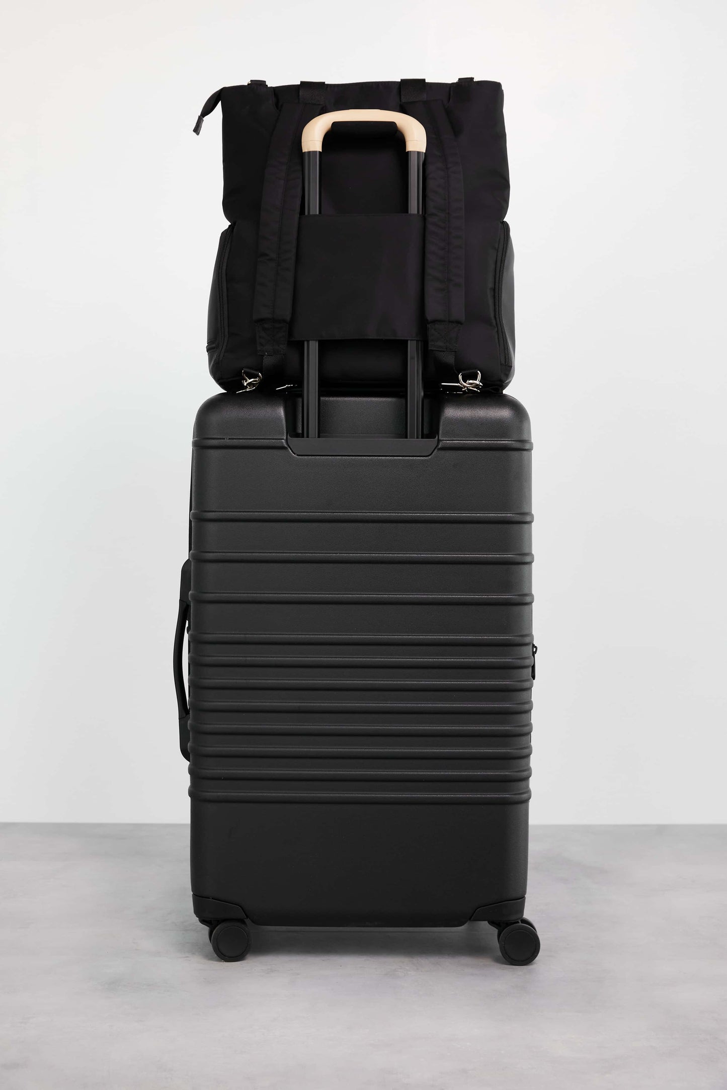 Pumping Backpack Black Back with Trolley Sleeve Stacked on Luggage